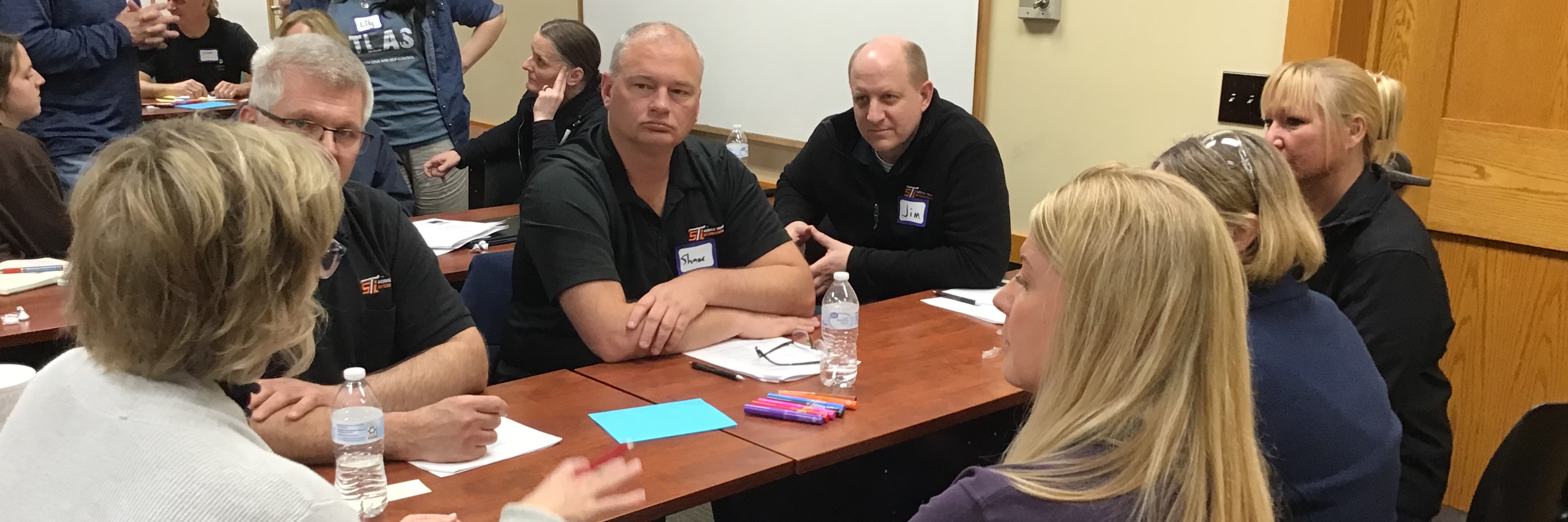 Adults in a leadership class having a small group discussion