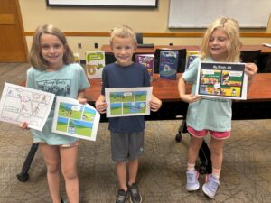 3 children holding up their finished projects